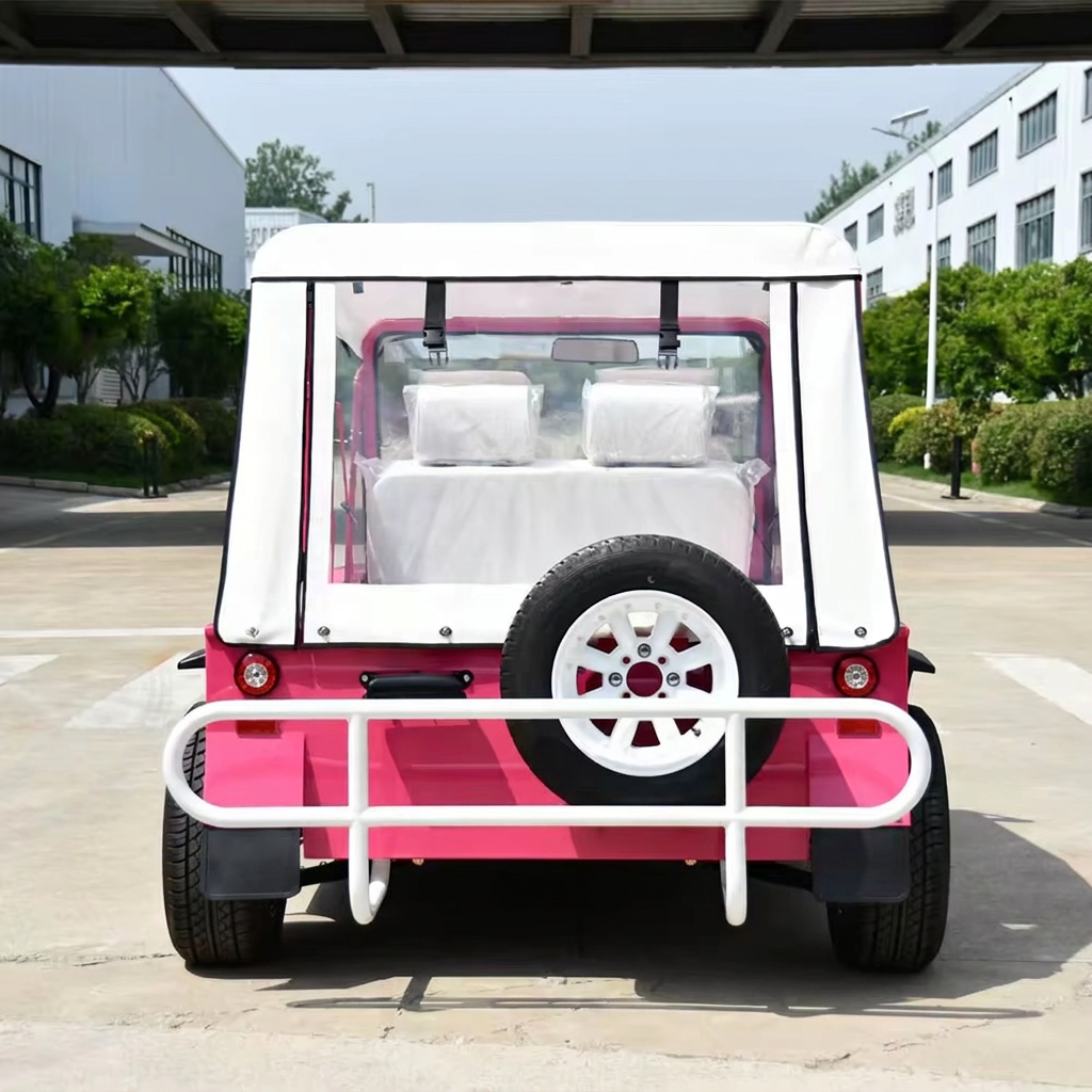 Pink Capri electric vehicle viewed from behind with spare wheel and rain cover