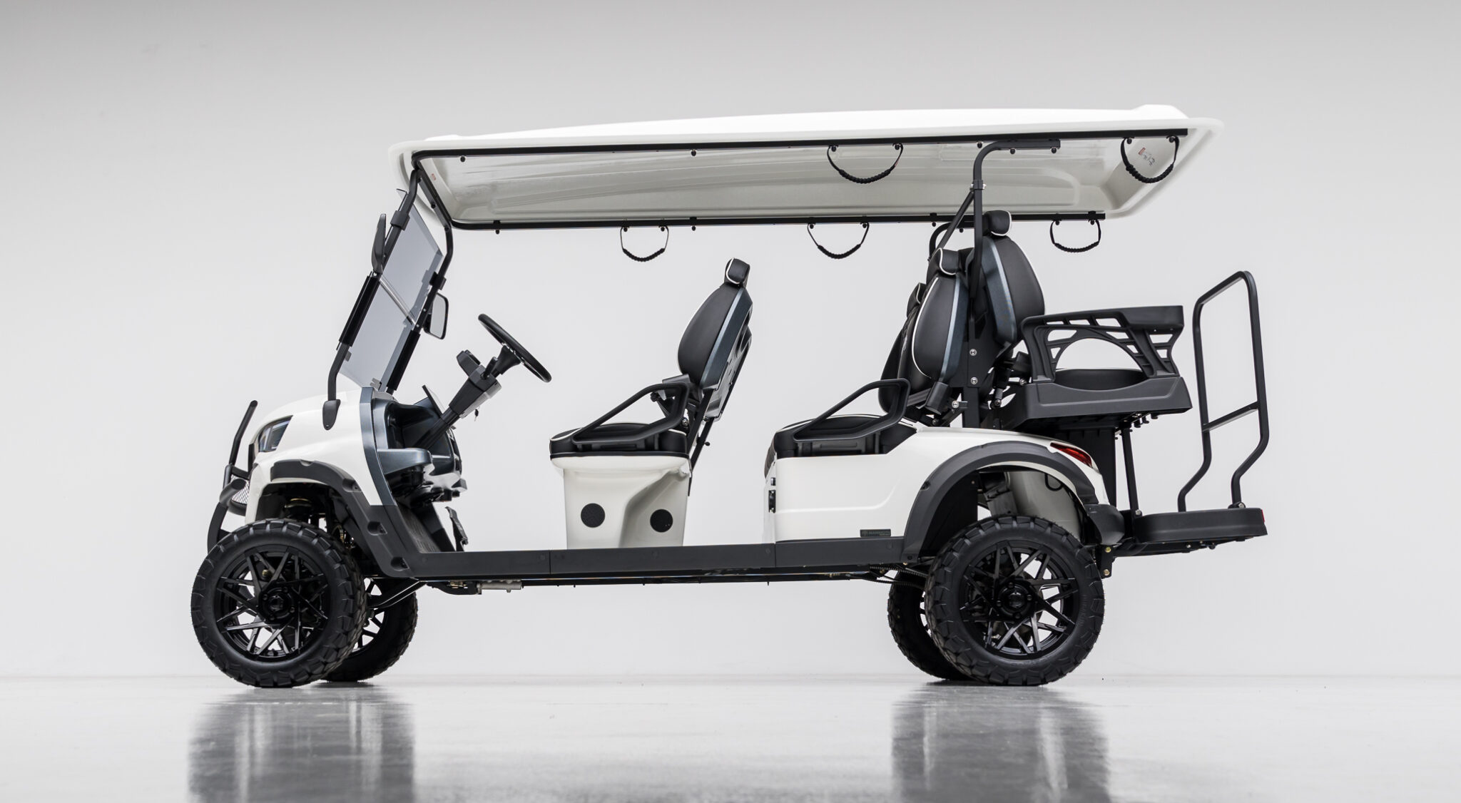 White luxury electric golf cart parked at a private villa on the French Riviera